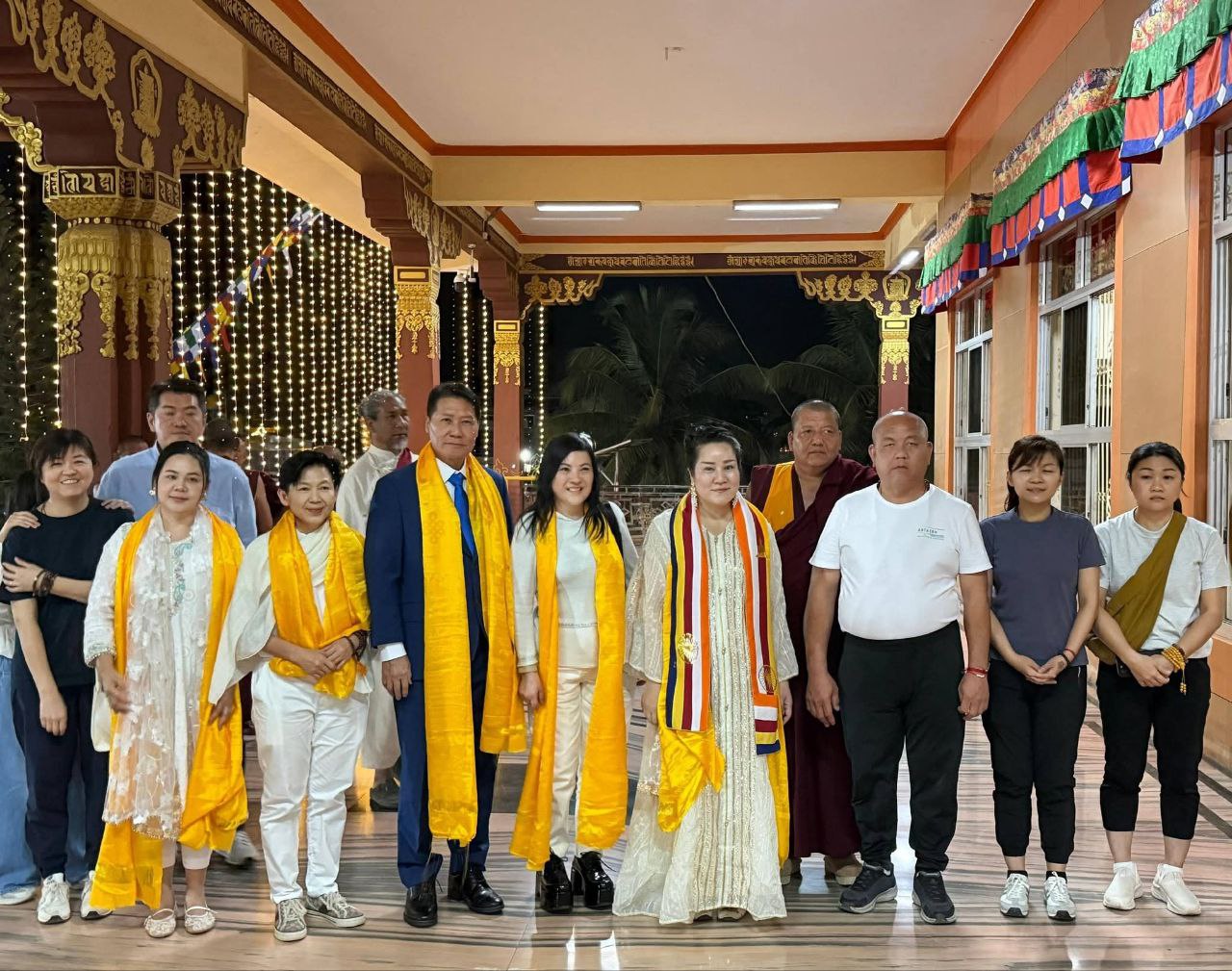 SHEKINAIH SIEW SIN YAP and J AARON K DAVID with the delegation on the monastery veranda