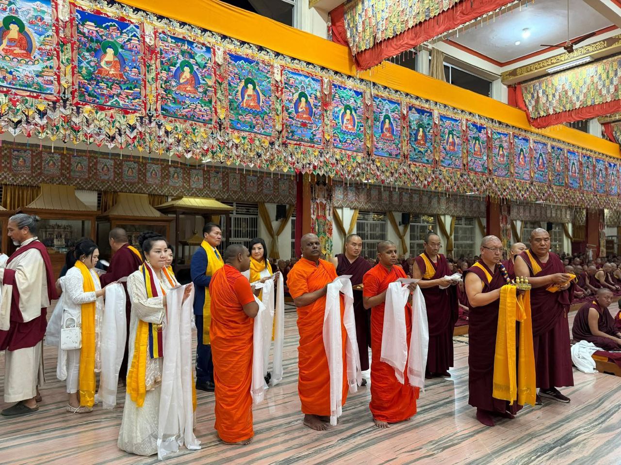 SHEKINAIH SIEW SIN YAP and J AARON K DAVID in the formal offering line, thangka hall