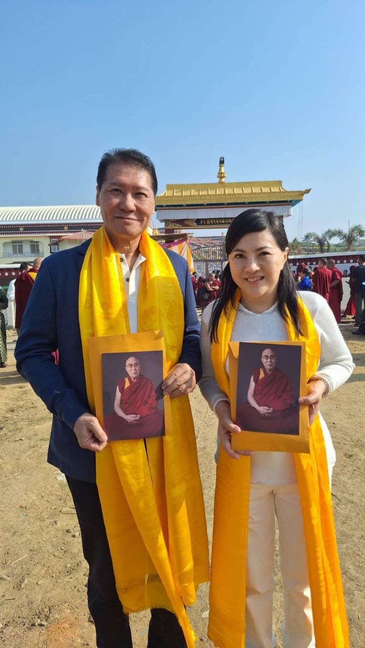 At Ganden Monastery with portraits of His Holiness