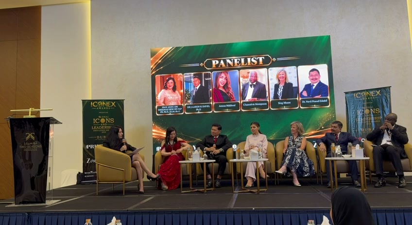 The panel of leaders seated on stage beneath a screen of panellists' portraits, Global Icons and Leadership Excellence Awards 2026, Dubai