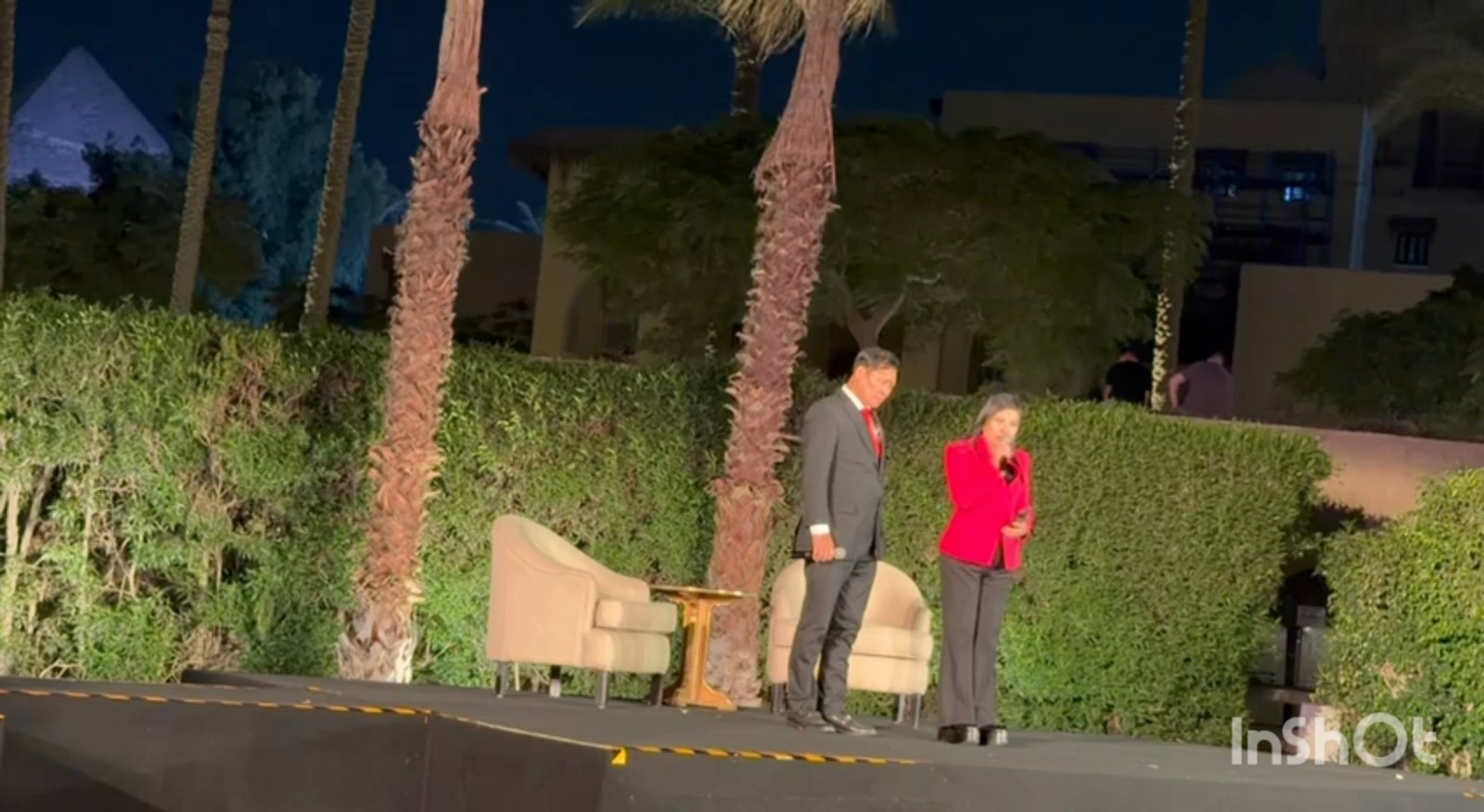 SHEKINAIH SIEW SIN YAP and J AARON K DAVID on the open-air evening stage among palms, Egypt