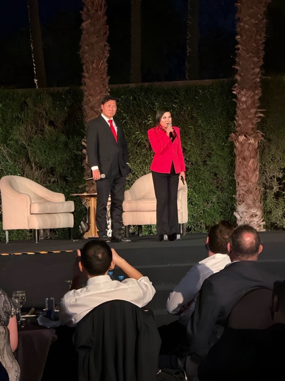 SHEKINAIH SIEW SIN YAP and J AARON K DAVID on the open-air evening stage in Egypt, with guests seated at dinner