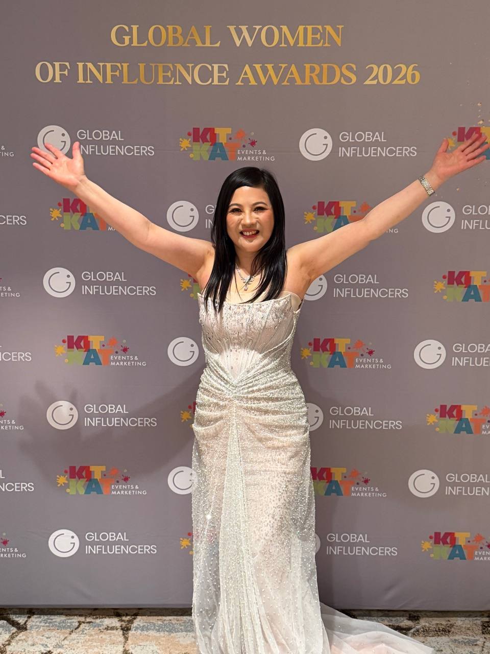 SHEKINAIH SIEW SIN YAP in a white beaded gown before the Global Women of Influence Awards 2026 backdrop, Singapore