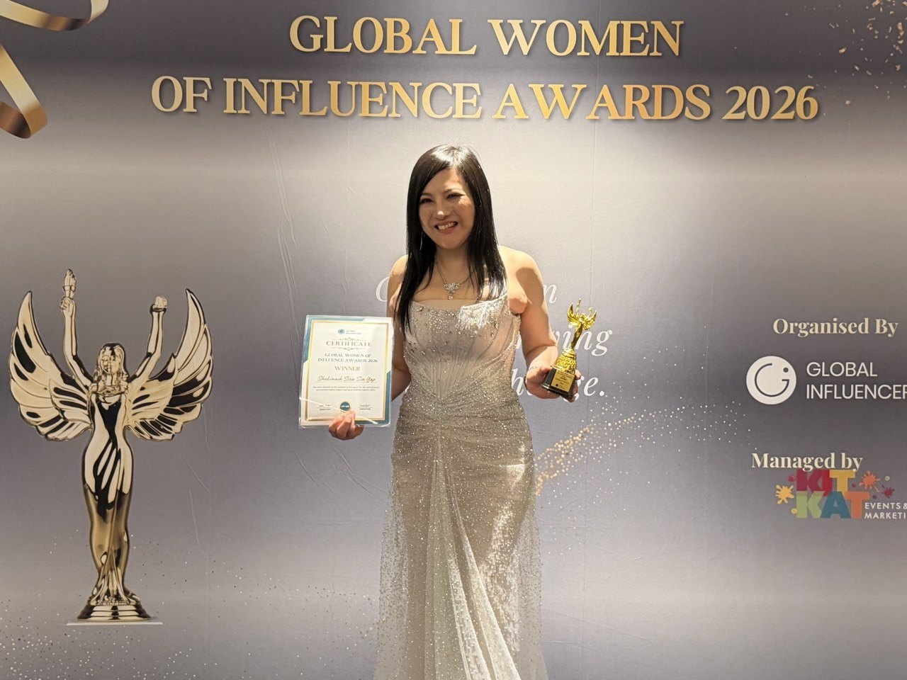 SHEKINAIH SIEW SIN YAP holding her Global Women of Influence Awards 2026 Winner certificate and trophy