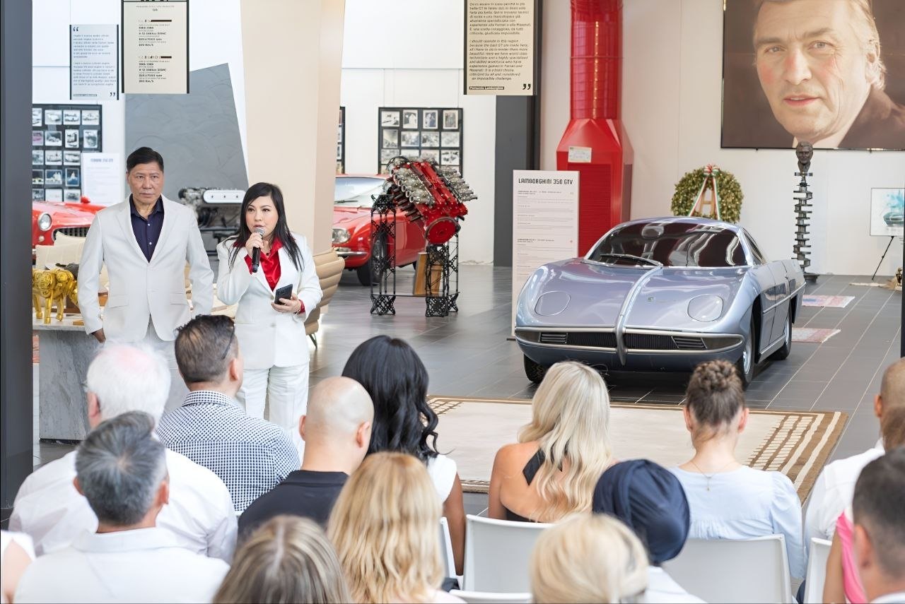 The audience seated in the Lamborghini museum, with the Lamborghini 350 GTV on display, Italy