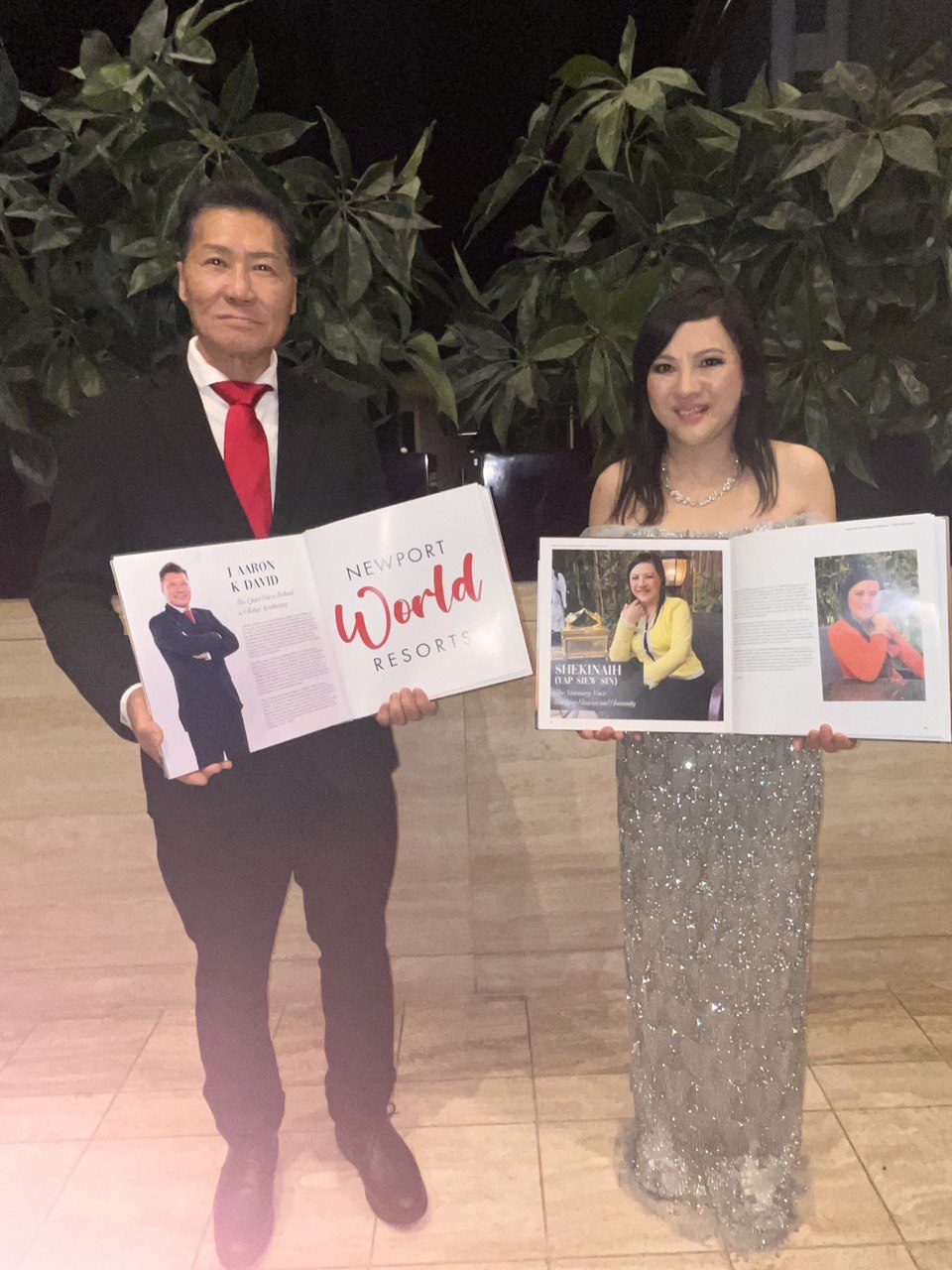 SHEKINAIH SIEW SIN YAP and J AARON K DAVID holding open Manila Up magazine spreads