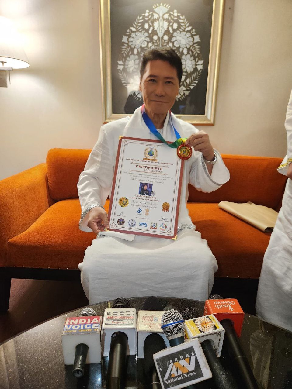 J AARON K DAVID at the DMGP press conference with certificate and medal