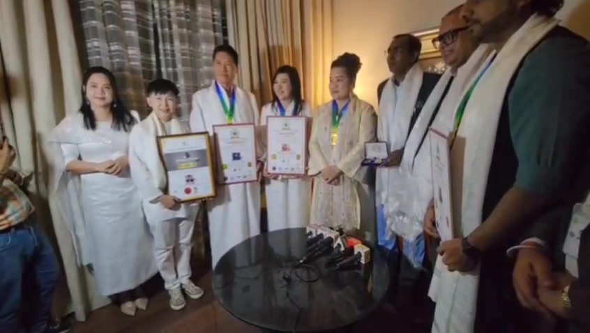 SHEKINAIH SIEW SIN YAP and J AARON K DAVID with the dignitaries, holding their DMGP Global Diplomacy Ambassador certificates at the Mumbai press ceremony, January 2026