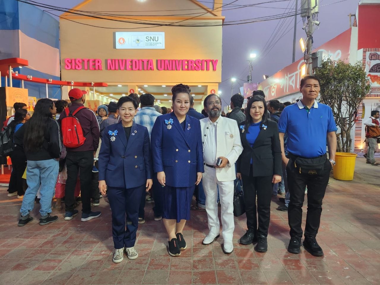 SHEKINAIH SIEW SIN YAP and J AARON K DAVID at the entrance of Sister Nivedita University, Kolkata
