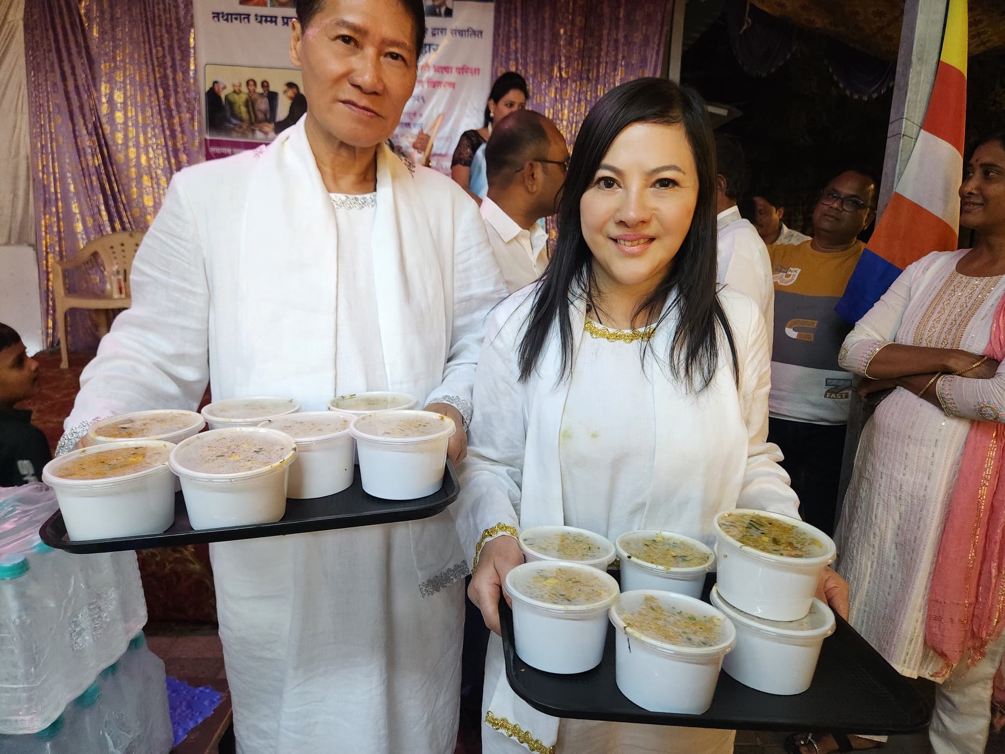 SHEKINAIH SIEW SIN YAP and J AARON K DAVID holding food trays — Buddhist gala & feeding the poor in Nagpur