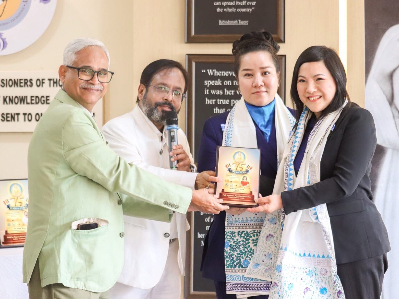 SHEKINAIH SIEW SIN YAP and J AARON K DAVID receiving the Walk for Peace plaque, Kolkata
