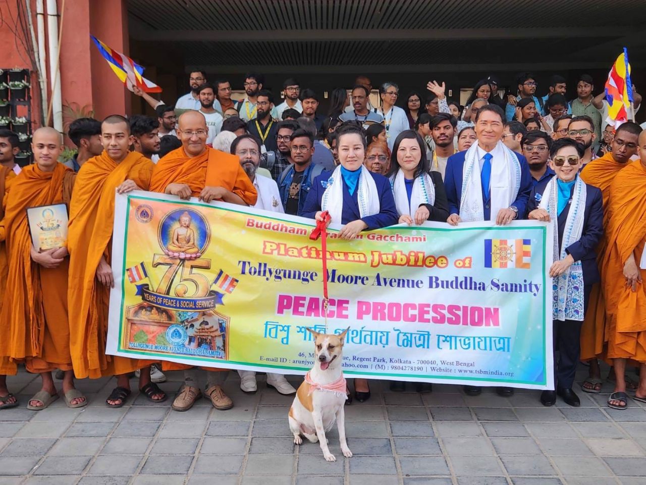 SHEKINAIH SIEW SIN YAP and J AARON K DAVID with the Walk for Peace delegation and Aloha the rescued temple dog, holding the 75 Years Peace Procession banner in Kolkata, India