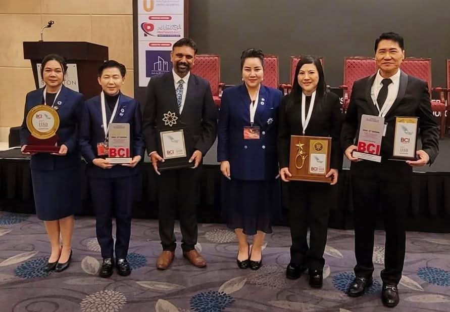 International IISA 2026 awardees lineup on stage — SHEKINAIH SIEW SIN YAP and J AARON K DAVID among honourees from Thailand, India, Egypt, the Philippines and the Sultanate of Oman