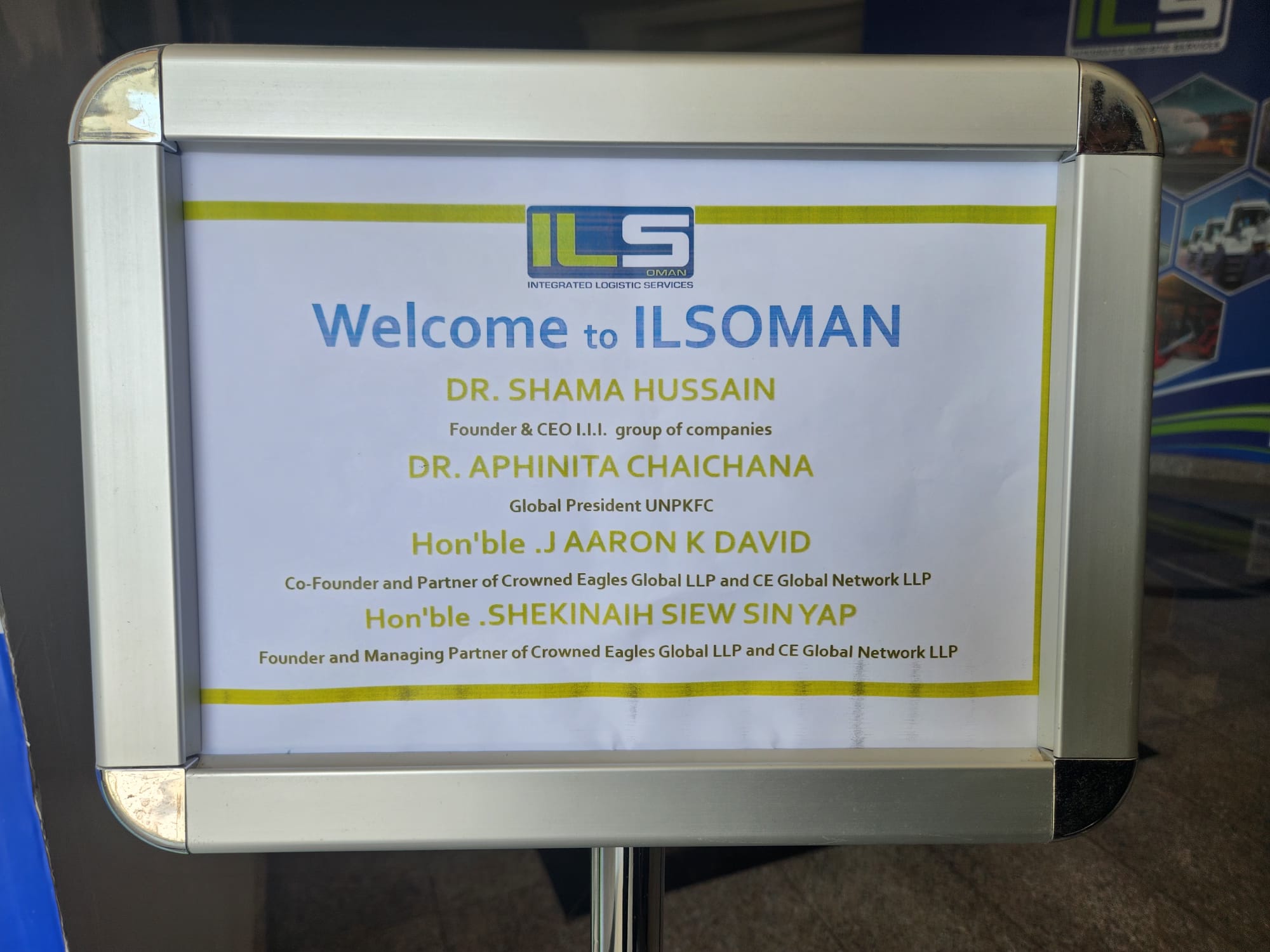 ILSOMAN — Integrated Logistic Services Oman — welcome sign honoring the Crowned Eagles Global delegation including Dr Shama Hussain, Dr Aphinita Chaichana, J AARON K DAVID and SHEKINAIH SIEW SIN YAP