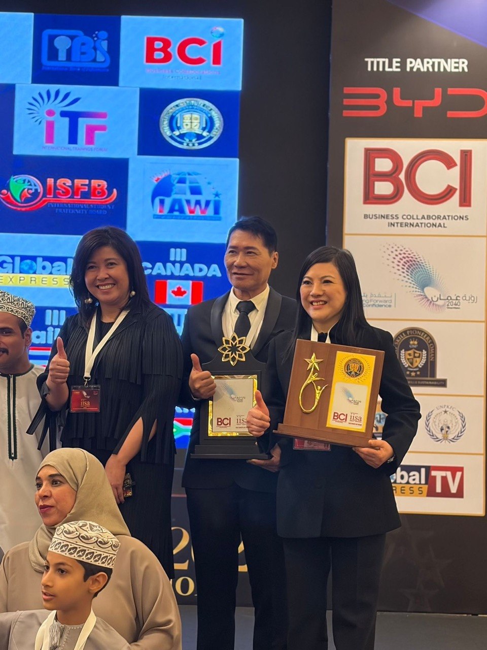 SHEKINAIH SIEW SIN YAP and J AARON K DAVID on the IISA 2026 stage with the Omani delegate, Sheraton Oman Hotel