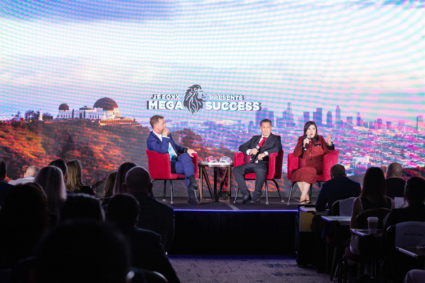 SHEKINAIH SIEW SIN YAP speaking on the Mega Success 2025 stage with Los Angeles skyline backdrop